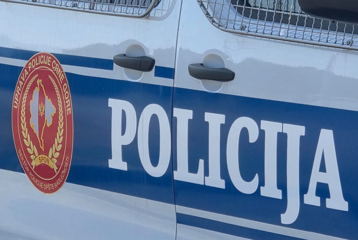Montenegro police car door with crest on a blue stripe and the word POLICIJA beside it